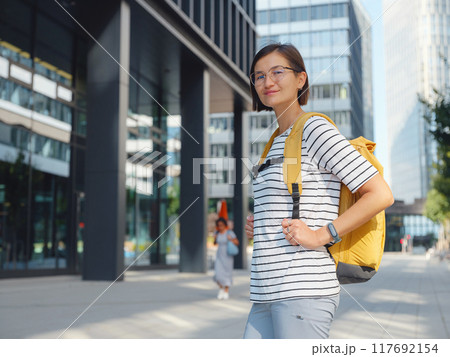 Asian woman over background of modern urban architecture in Vienna. 117692154