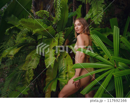 Portrait of a beautiful woman in tropical jungle 117692166