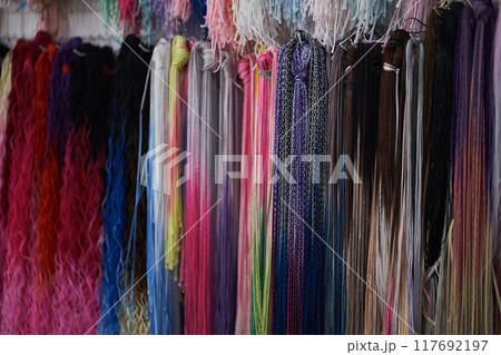 Bright colored pigtails of zizi from kanekalon. Artificial hair for braiding Afro-pigtails and hairstyles. Bright colors. Textured wallpaper. With space to copy. High quality photo Bright colored pigtails of zizi from kanekalon. Artificial hair for braiding Afro-pigtails and hairstyles. Bright colors. Textured wallpaper. With space to copy. High quality photo 117692197