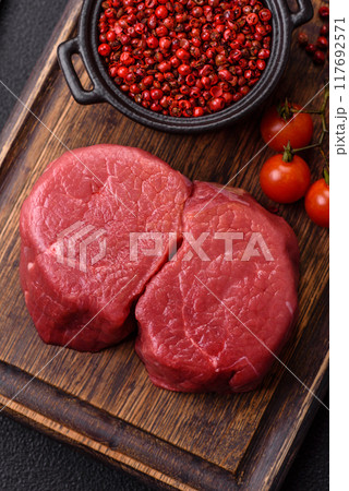 Fresh juicy raw beef medallions with salt and spices 117692571