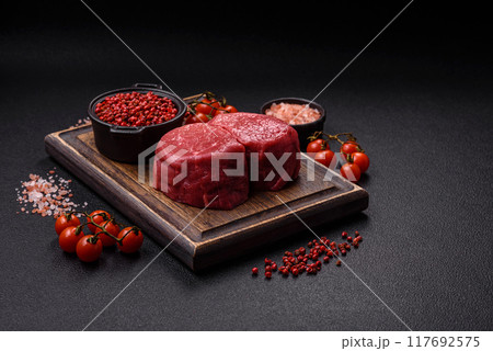 Fresh juicy raw beef medallions with salt and spices 117692575