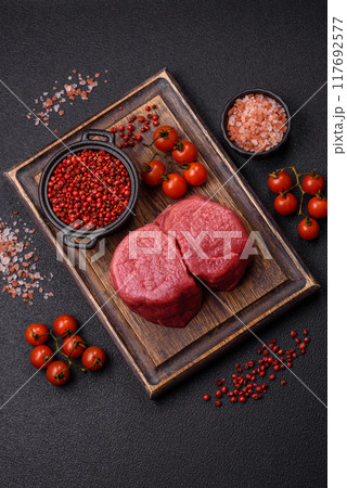 Fresh juicy raw beef medallions with salt and spices Fresh juicy raw beef medallions with salt and spices 117692577