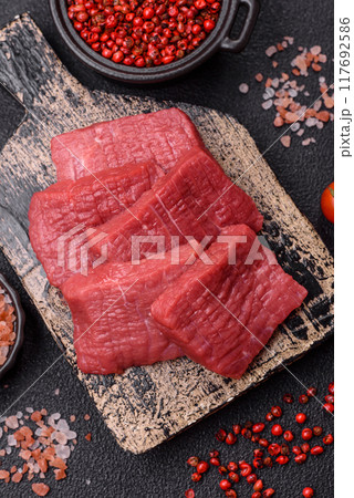 Juicy fresh raw beef meat with salt, spices and herbs 117692586