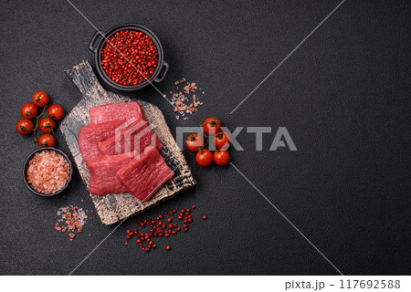 Juicy fresh raw beef meat with salt, spices and herbs 117692588