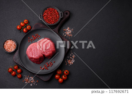 Fresh juicy raw beef medallions with salt and spices Fresh juicy raw beef medallions with salt and spices 117692671