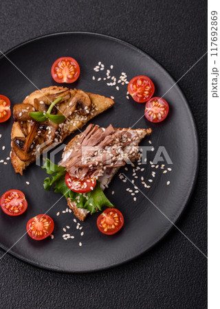 Variation of several toasts or bruschetta with prosciutto, mushrooms and veal 117692869