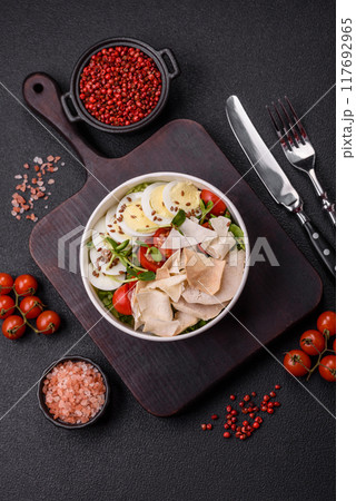 Delicious fresh caesar salad in a bowl with chicken breast, egg, tomatoes Delicious fresh caesar salad in a bowl with chicken breast, egg, tomatoes 117692965