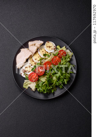 Delicious fresh caesar salad in a bowl with chicken breast, egg, tomatoes 117692970