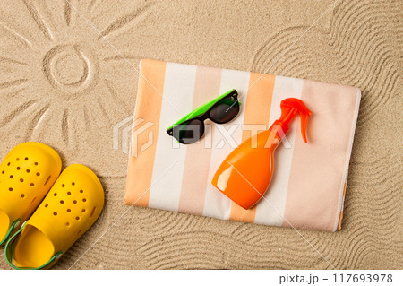drawing on the sand, sun and waves,sunglasses, with an orange bottle, yellow rubber slippers, beach towel, sun spray,on the sand, top view, no people, 117693978