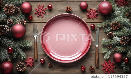 Festive holiday table setting with pink plate, silverware, and winter decorations 117694527