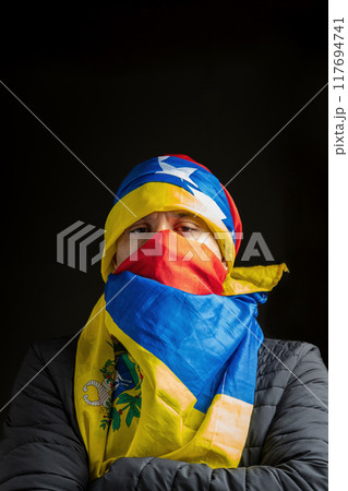 Symbol of repression, hooded fighting for freedom, resistance for democracy in Venezuela 117694741