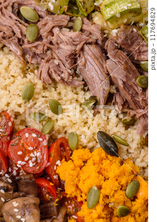 Bowl of food with beef, bulgur, tomatoes, mushrooms, zucchini Bowl of food with beef, bulgur, tomatoes, mushrooms, zucchini 117694829