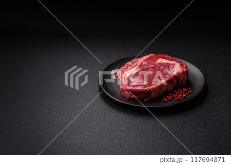 Fresh, raw beef steak with salt, spices and herbs Fresh, raw beef steak with salt, spices and herbs 117694871