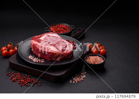 Fresh, raw beef steak with salt, spices and herbs 117694879