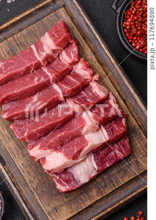 Fresh raw beef cut into slices with salt, spices 117694890