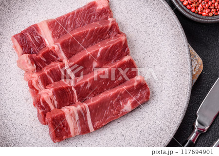 Fresh raw beef cut into slices with salt, spices 117694901