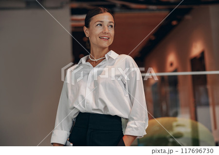 Confident Professional Woman in a Modern and Dynamic Office Workplace Environment Confident Professional Woman in a Modern and Dynamic Office Workplace Environment 117696730