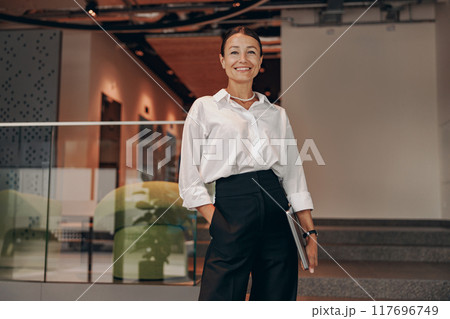 A Confident Businesswoman Thrives in a Modern Office Setting, Embracing Her Professionalism 117696749