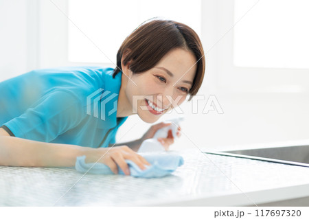 キッチンを掃除する家事代行サービスの女性 117697320