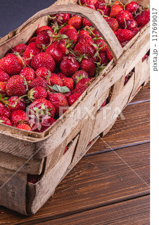 ripe strawberries in a wooden box on the table close up ripe strawberries in a wooden box on the table close up 117699017