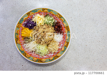 Serving of vegetarian Yusheng dish consisting vegetables and fruits for healthier diet during Chinese New Year celebration, suitable for vegan. 117700661