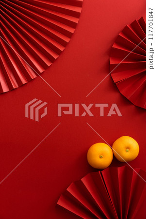 Chinese new year background design flat lay image with mandarin oranges and red paper fan 117701847