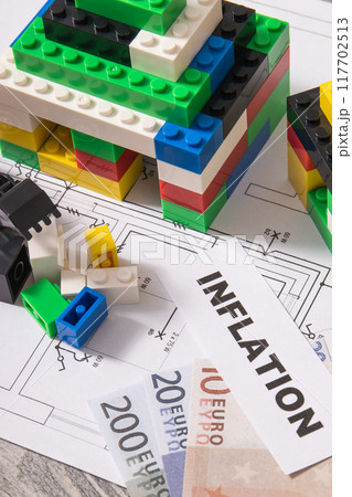 Houses made of toy blocks, house plan, euro banknotes with inscription inflation Houses made of toy blocks, house plan, euro banknotes with inscription inflation 117702513