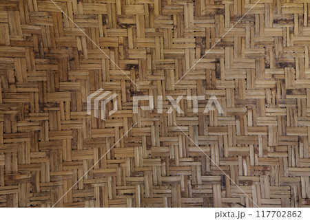 Old woven bamboo wall, rural people's house. Traditional bamboo webbing background texture. Old woven bamboo wall, rural people's house. Traditional bamboo webbing background texture. 117702862
