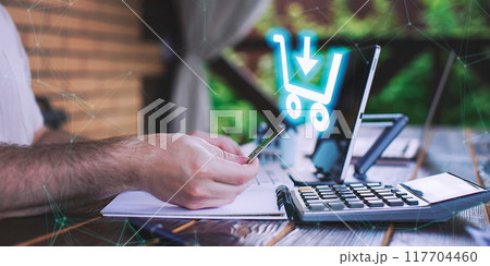 A man adds items to his cart while shopping in an international online store. E-commerce marketing offers discounts and free home delivery from any country. 117704460