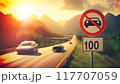 A high-speed highway in a picturesque mountainous area. There is a road sign on the side of the road warning about the speed limit 117707059