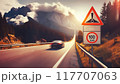 A high-speed highway in a picturesque mountainous area. There is a road sign on the side of the road warning about the speed limit 117707063