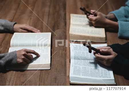 Asian men and women hands praying to god with the bible. Pray for god blessing. Religious beliefs Christian life crisis prayer to god. 117707914