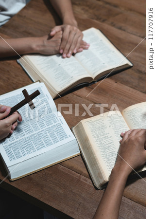 Asian men and women hands praying to god with the bible. Pray for god blessing. Religious beliefs Christian life crisis prayer to god. 117707916