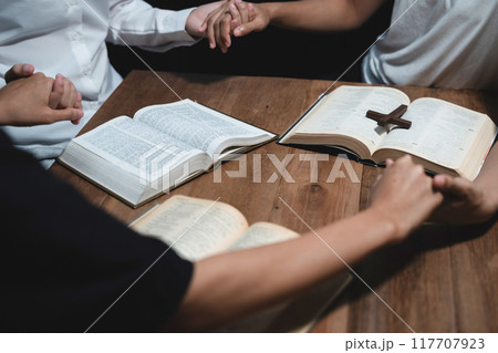 Asian men and women hands praying to god with the bible. Pray for god blessing. Religious beliefs Christian life crisis prayer to god. 117707923