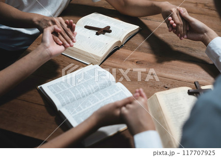 Asian men and women hands praying to god with the bible. Pray for god blessing. Religious beliefs Christian life crisis prayer to god. 117707925