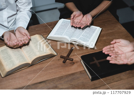 Asian men and women hands praying to god with the bible. Pray for god blessing. Religious beliefs Christian life crisis prayer to god. 117707929