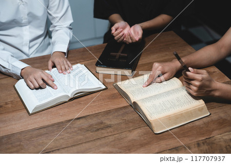 Asian men and women hands praying to god with the bible. Pray for god blessing. Religious beliefs Christian life crisis prayer to god. Asian men and women hands praying to god with the bible. Pray for god blessing. Religious beliefs Christian life crisis prayer to god. 117707937