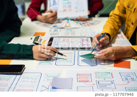 UX developer and ui designer brainstorming about mobile app interface wireframe design with customer breif and color code, User experience concept 117707948