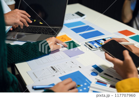 UX developer and ui designer brainstorming about mobile app interface wireframe design with customer breif and color code, User experience concept UX developer and ui designer brainstorming about mobile app interface wireframe design with customer breif and color code, User experience concept 117707960