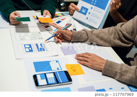 UX developer and ui designer brainstorming about mobile app interface wireframe design with customer breif and color code, User experience concept UX developer and ui designer brainstorming about mobile app interface wireframe design with customer breif and color code, User experience concept 117707969