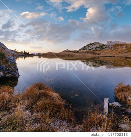 Early morning autumn alpine Dolomites mountain scene. Peaceful Valparola Pass and Lake view, Belluno, Italy. Early morning autumn alpine Dolomites mountain scene. Peaceful Valparola Pass and Lake view, Belluno, Italy. 117708318