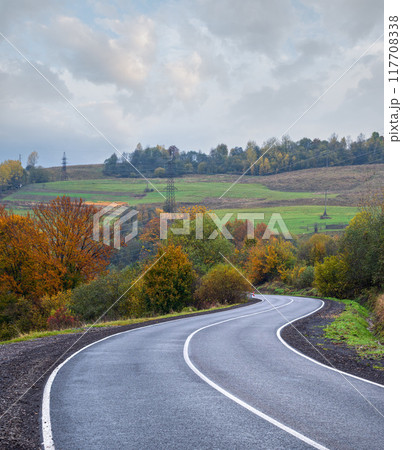 Hazy and overcast Carpathian Mountains and highway on mountain pass, Ukraine. 117708338