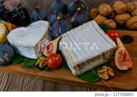Selection of French cheeses from Normandy, AOP, Livarot, Neufchatel, Pont l'eveque, Rye bread, figs 117708805