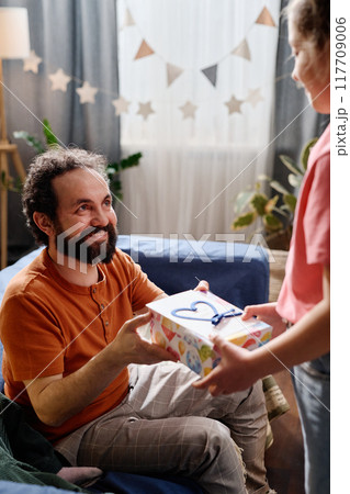 Celebrating Birthday with Joyful Smiles and Gift Giving 117709006