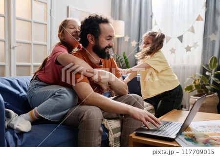 Father Enjoying Time with Daughters at Home Father Enjoying Time with Daughters at Home 117709015
