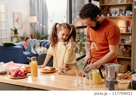 Father and Daughter Preparing Breakfast in Cozy Kitchen 117709051