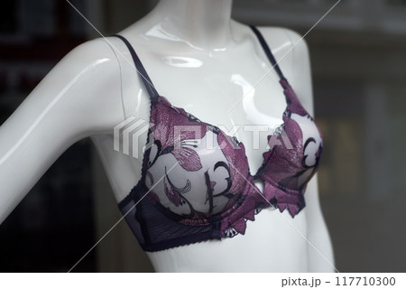Closeup of purple bra on mannequin in a fashion store showroom Closeup of purple bra on mannequin in a fashion store showroom 117710300