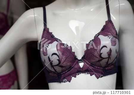 Closeup of purple bra on mannequin in a fashion store showroom Closeup of purple bra on mannequin in a fashion store showroom 117710301