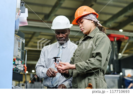 Collaborating on Machinery in Industrial Factory Setting Collaborating on Machinery in Industrial Factory Setting 117710693