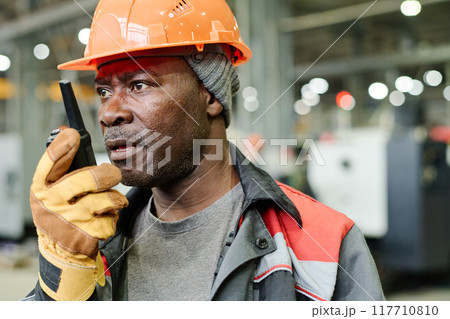 Speaking on Walkie Talkie in Construction Site 117710810